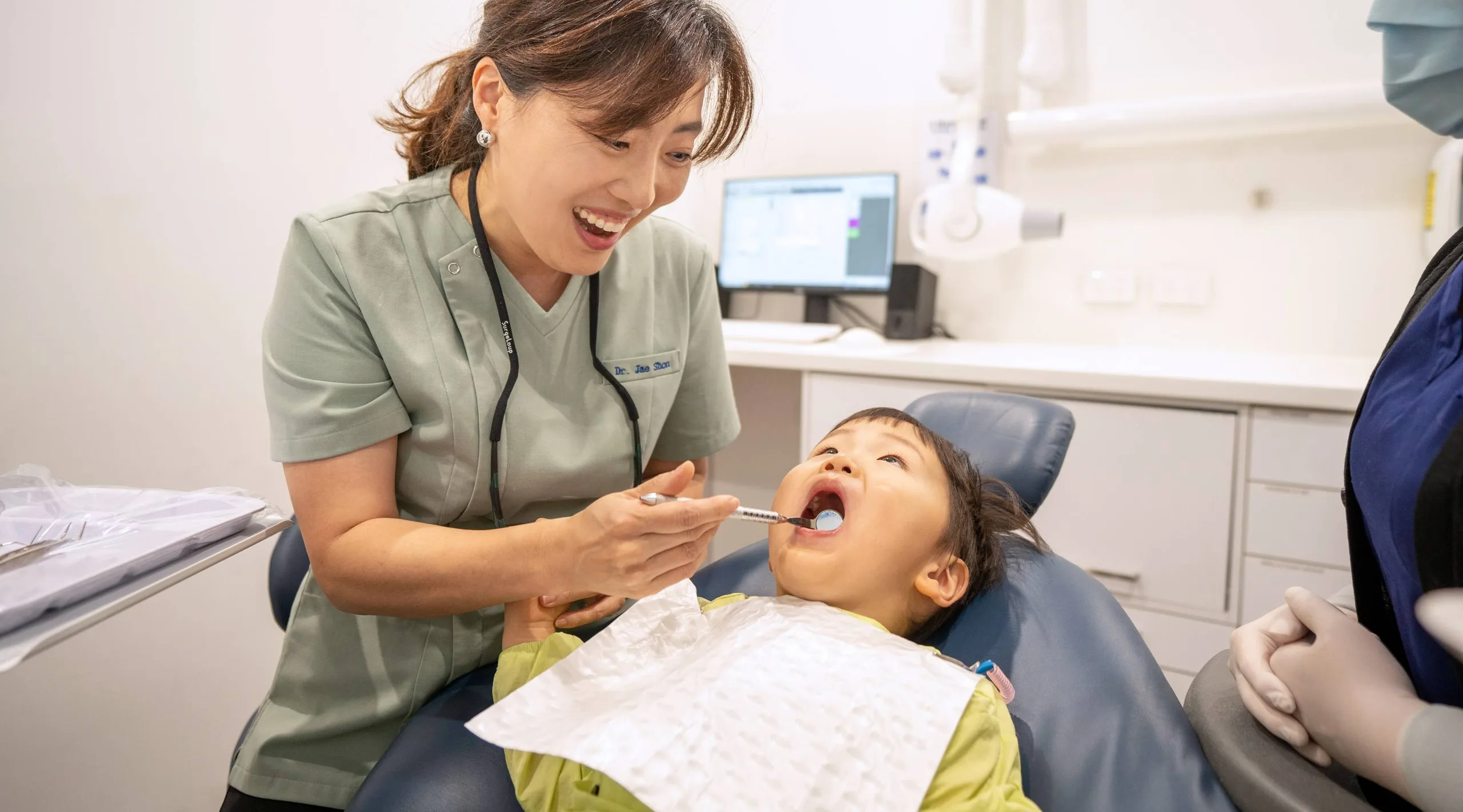 A young child smiling comfortably during a dental visit