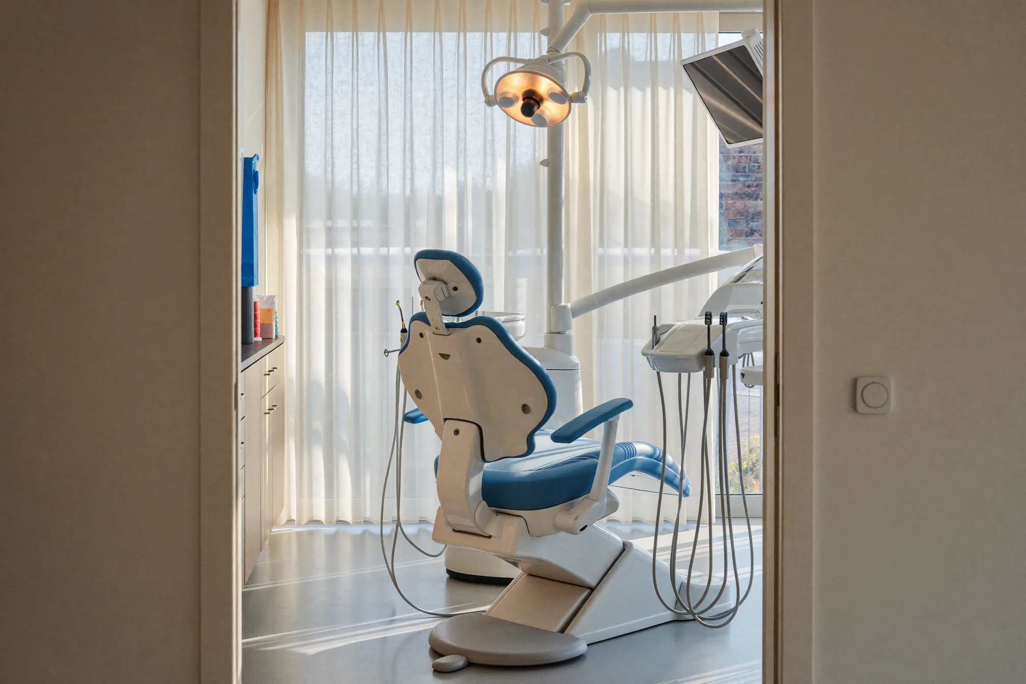 Dentist pointing to an infected tooth on a screen while reassuring a patient